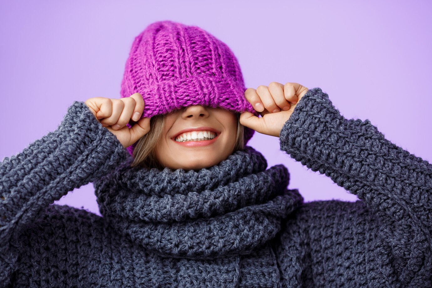 young-beautiful-fair-haired-woman-knited-hat-sweater-smiling-violet_176420-7665
